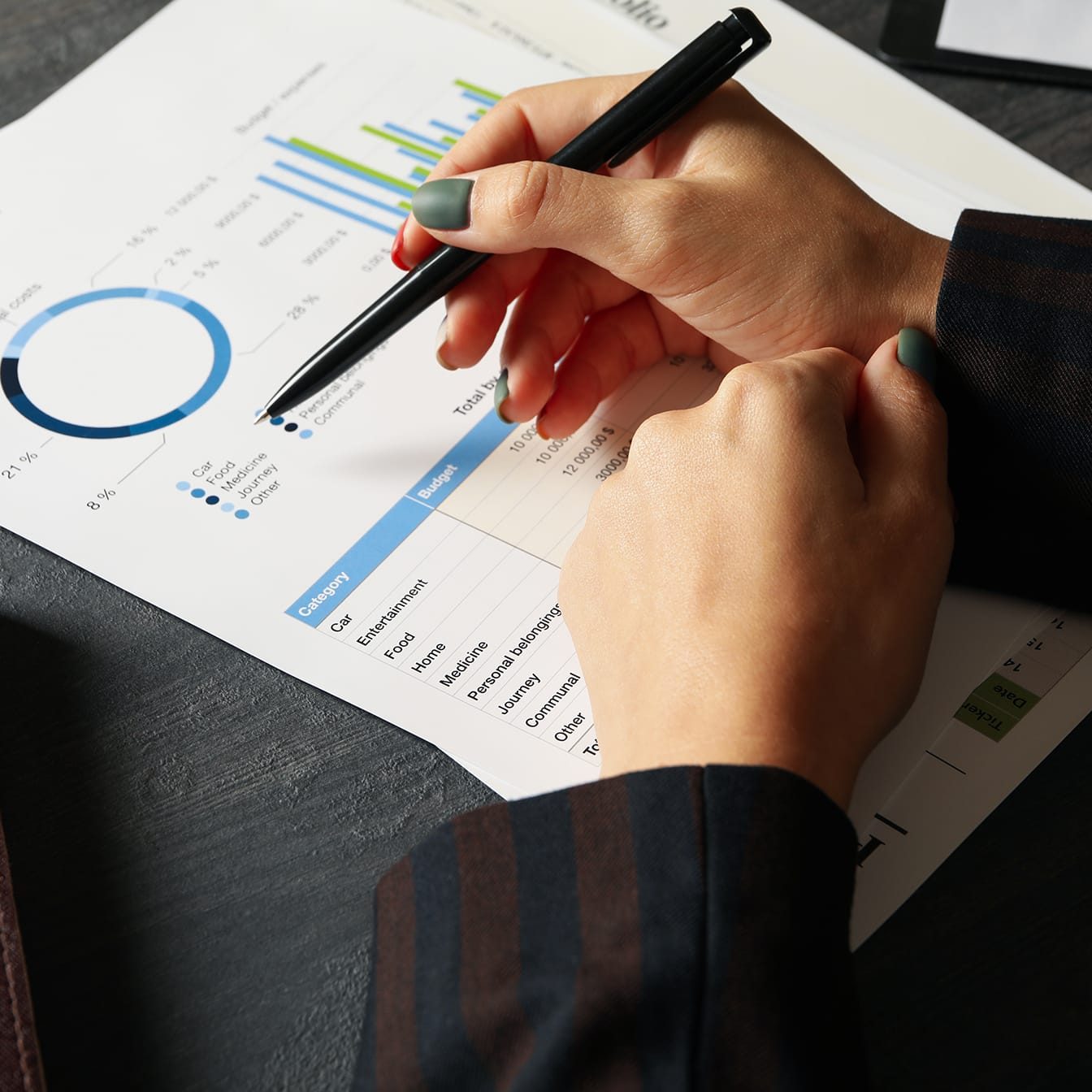 Business woman doing financial planning on black table with docu Business woman doing financial planning on black table with documents
